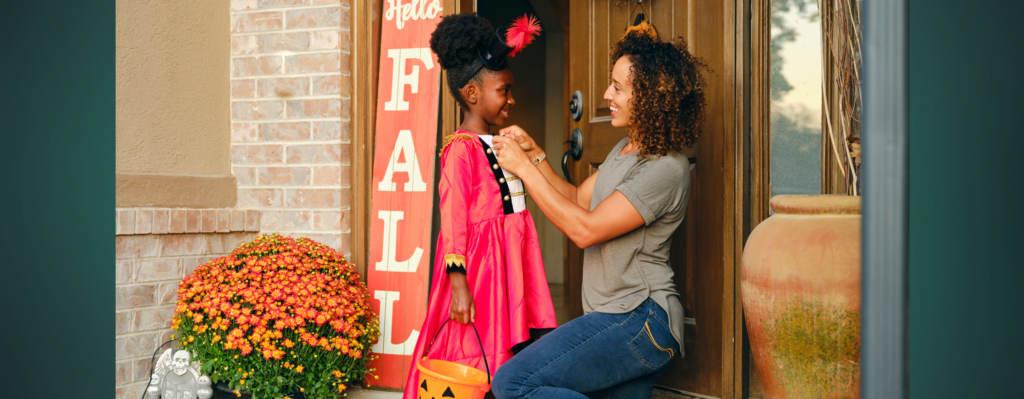 Mother and daughter on the porch before going trick or treating