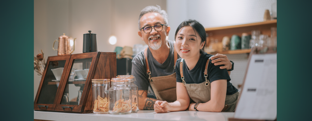 Father and daughter smiling in family owned business